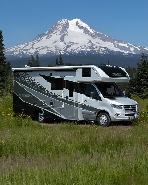 Class C motorhome parked in front of Mount Hood with scenic background